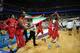 Iranian players and officials carry their national flag and run around the court after defeating the Philippines in the men's Asia championship basketball final game in Manila on August 11, 2013. Iran routed the Philippines 85-71 to bag gold at the 27th FIBA Asian men's basketball championship on August 11. AFP PHOTO/TED ALJIBE (Photo credit should read TED ALJIBE/AFP/Getty Images)