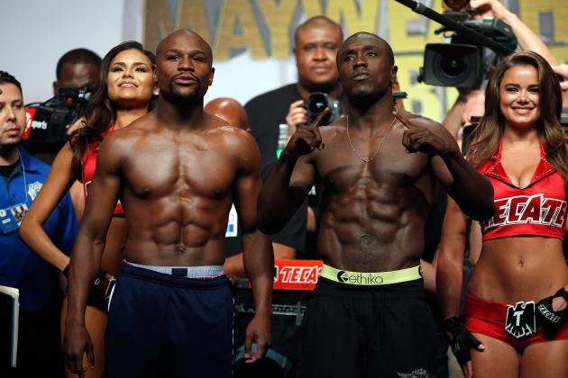 LAS VEGAS, NV - SEPTEMBER 11:  Boxers Floyd Mayweather Jr. (L) and Andre Berto face off during their official weigh-in at MGM Grand Garden Arena on September 11, 2015 in Las Vegas, Nevada. Mayweather will defend his WBC/WBA welterweight titles against Berto on September 12 at MGM Grand in Las Vegas.  (Photo by Ezra Shaw/Getty Images)
