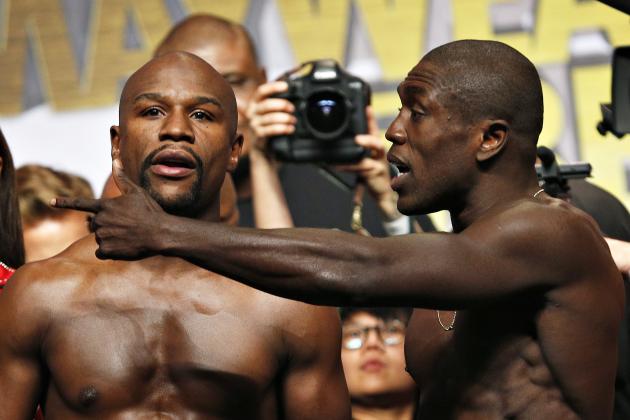 Floyd Mayweather Jr., left, and Andre Berto speak as they pose for photographers during weigh-ins Friday, Sept. 11, 2015, in Las Vegas. The two are scheduled to fight in a welterweight title bout Saturday in Las Vegas. (AP Photo/John Locher)