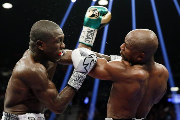 Floyd Mayweather Jr., right, hits Andre Berto during their welterweight title boxing bout Saturday, Sept. 12, 2015, in Las Vegas. (AP Photo/Steve Marcus)
