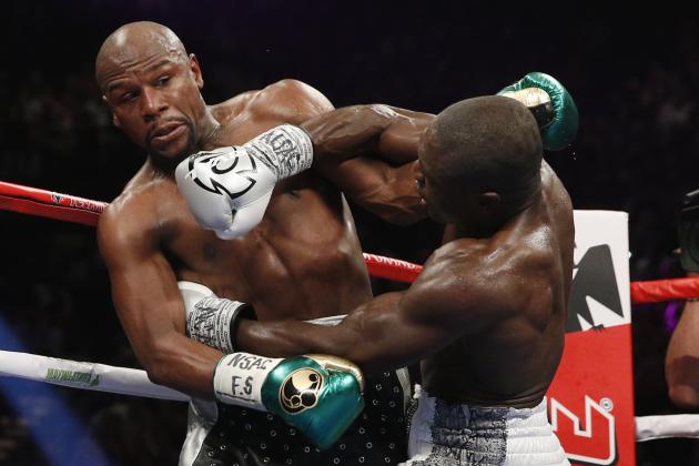 Andre Berto, right, punches Floyd Mayweather Jr. during their welterweight title boxing bout Saturday, Sept. 12, 2015, in Las Vegas. (AP Photo/John Locher)