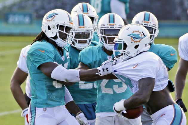 Miami Dolphins cornerback Walt Aikens, left, tussles with wide receiver Jarvis Landry, right, after Landry knocked off cornerback Bobby McCain's helmet during a play at the teams NFL football training camp, Wednesday, Aug. 5, 2015 in Davie, Fla. (AP Photo/Wilfredo Lee)