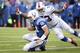 Indianapolis Colts quarterback Andrew Luck (12) slides in front of Buffalo Bills outside linebacker Nigel Bradham (53) during the second half of an NFL football game on Sunday, Sept. 13, 2015, in Orchard Park, N.Y. Buffalo won 27-14. (AP Photo/Gary Wiepert)