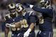 St. Louis Rams defensive tackle Aaron Donald, center, is congratulated by teammates Michael Brockers, right, and defensive end Eugene Sims after sacking Seattle Seahawks quarterback Russell Wilson for a 4-yard loss during the third quarter of an NFL football game Sunday, Sept. 13, 2015, in St. Louis. (AP Photo/Tom Gannam)
