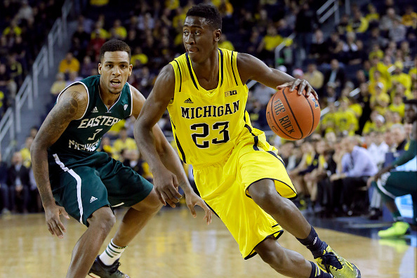ANN ARBOR, MI - DECEMBER 9:  Caris LeVert #23 of the Michigan Wolverines drives to the basket against Anali Okoloji #3 of the Eastern Michigan Eagles during the first half at Crisler Arena on December 9, 2014 in Ann Arbor, Michigan. (Photo by Duane Burleson/Getty Images)
