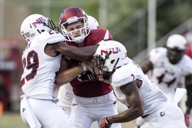 Sep 20, 2014; Fayetteville, AR, USA; Northern Illinois Huskies  cornerback Paris Logan (29) and safety Marlon Moore (2) tackle Arkansas Razorbacks wide receiver Cody Hollister (81) during the first half of a game at Donald W. Reynolds Razorback Stadium. Arkansas defeated NIU 52-14. Mandatory Credit: Beth Hall-USA TODAY Sports