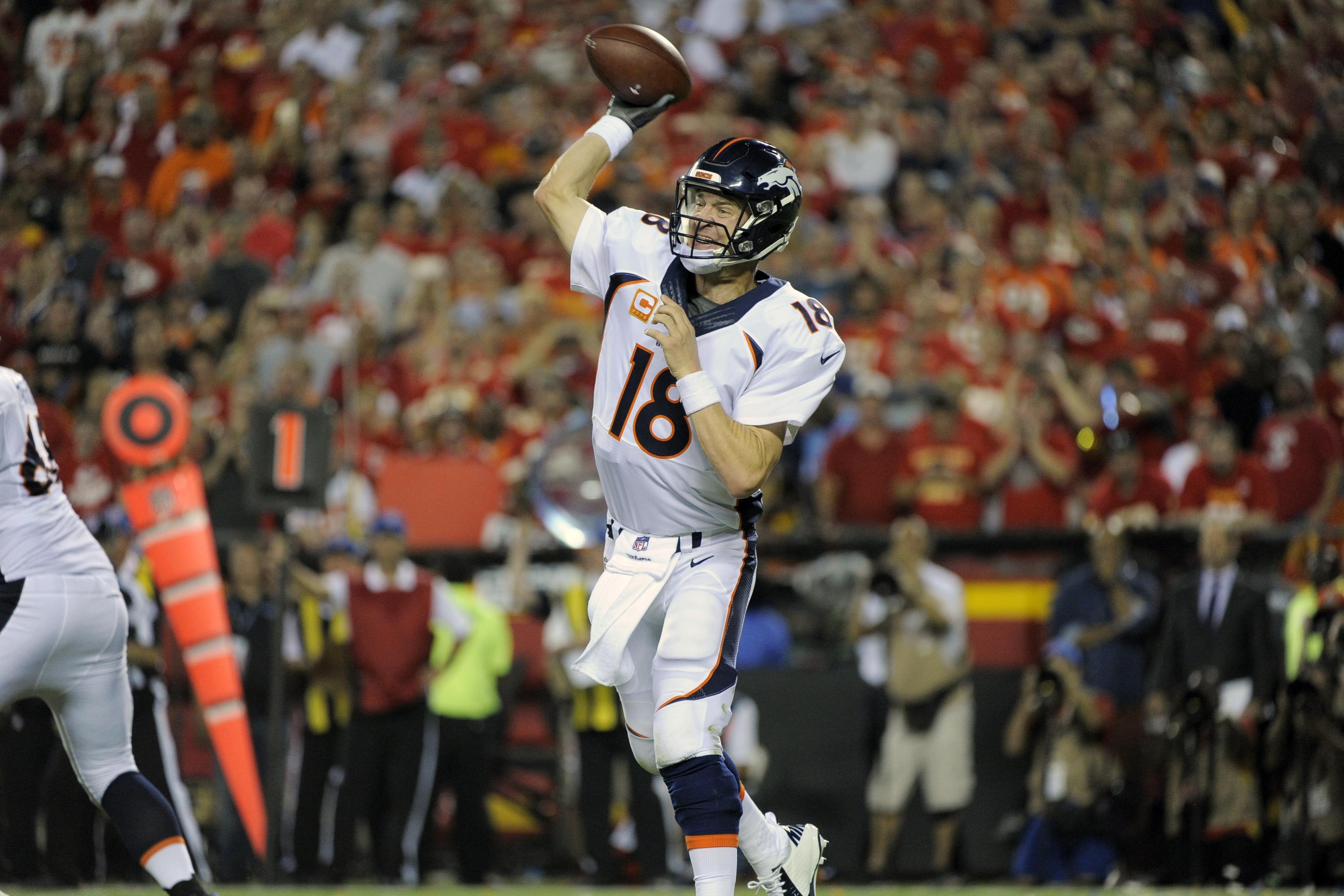 Denver Broncos quarterback Peyton Manning (18) sits on the bench