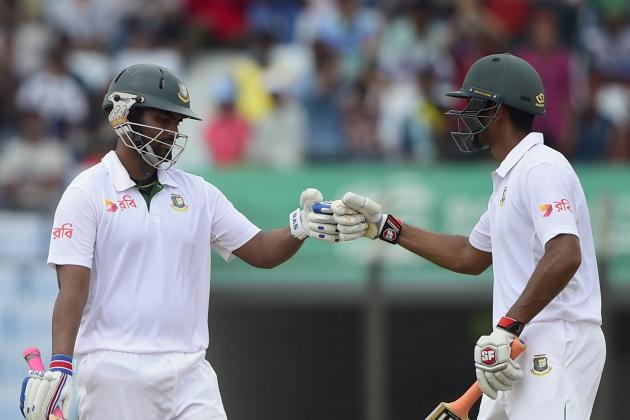 Bangladesh cricketer Tamim Iqbal (L) celebrates his half century (50 runs) with teammate Mohammad Mahmudullah (R) during the second day of the first cricket Test match between Bangladesh and South Africa at the Zahur Ahmed Chowdhury Stadium in Chittagong on July 22, 2015. AFP PHOTO/ Munir uz ZAMAN        (Photo credit should read MUNIR UZ ZAMAN/AFP/Getty Images)