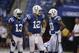 Indianapolis Colts quarterback Andrew Luck, center, talks with receiver T.Y. Hilton, left, and Donte Moncrief before an NFL football game against the Tennessee Titans in Indianapolis, Sunday, Sept. 28, 2014. (AP Photo/Darron Cummings)