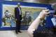 Former UCLA and Lakers great Kareem Abdul-Jabbar poses for a photo by a commorative banner as he arrives for a memorial service for the late UCLA basketball coach John Wooden, at Pauley Pavilion in Los Angeles, Saturday, June 26, 2010. (AP Photo/Reed Saxon)