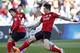 Atletico Mineiro's Diego Tardelli, center, kicks to score a goal past Guangzhou Evergrande's Zhang Linpeng, right, during the third place soccer match between Guangzhou Evergrande and Atletico Mineiro at the Club World Cup soccer tournament in Marrakech, Morocco, Saturday, Dec. 21, 2013. (AP Photo/Christophe Ena)