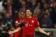 Bayern's Robert Lewandowski, right, celebrates with teammate Douglas Costa after scoring during the German Bundesliga soccer match between FC Bayern Munich and VfL Wolfsburg at the Allianz Arena stadium in Munich, Germany, Tuesday, Sept. 22, 2015. Lewandowski made Bundesliga history on Tuesday after scoring five goals in the space of nine minutes as Bayern Munich came from behind to rout Wolfsburg 5-1 and move to the top of the standings. (AP Photo/Matthias Schrader)