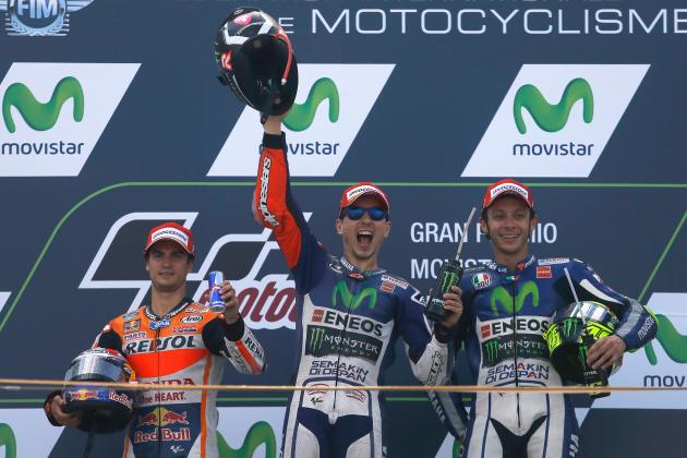 Moto GP rider Jorge Lorenzo of Spain, center, celebrates on the podium after winning  the Aragon Motorcycle Grand Prix at the Aragon Motorland racetrack in Alcaniz, Spain, Sunday, Sept. 27, 2015. At left is second placed Dani Pedrosa of Spain and at right is third placed Valentino Rossi of Italy. (AP Photo/Francisco Seco)
