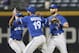 Toronto Blue Jays outfielders, from left, Ben Revere, Jose Bautista and Kevin Pillar celebrate after the Blue Jays defeated the Atlanta Braves 5-0 in a baseball game Thursday, Sept. 17, 2015, in Atlanta. (AP Photo/John Bazemore)