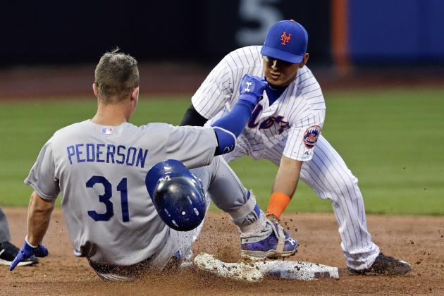 New York Mets shortstop Ruben Tejada, right, tags out Los Angeles Dodgers' Joc Pederson (31) at second base during the third inning of a baseball game Saturday, July 25, 2015, in New York. (AP Photo/Frank Franklin II)