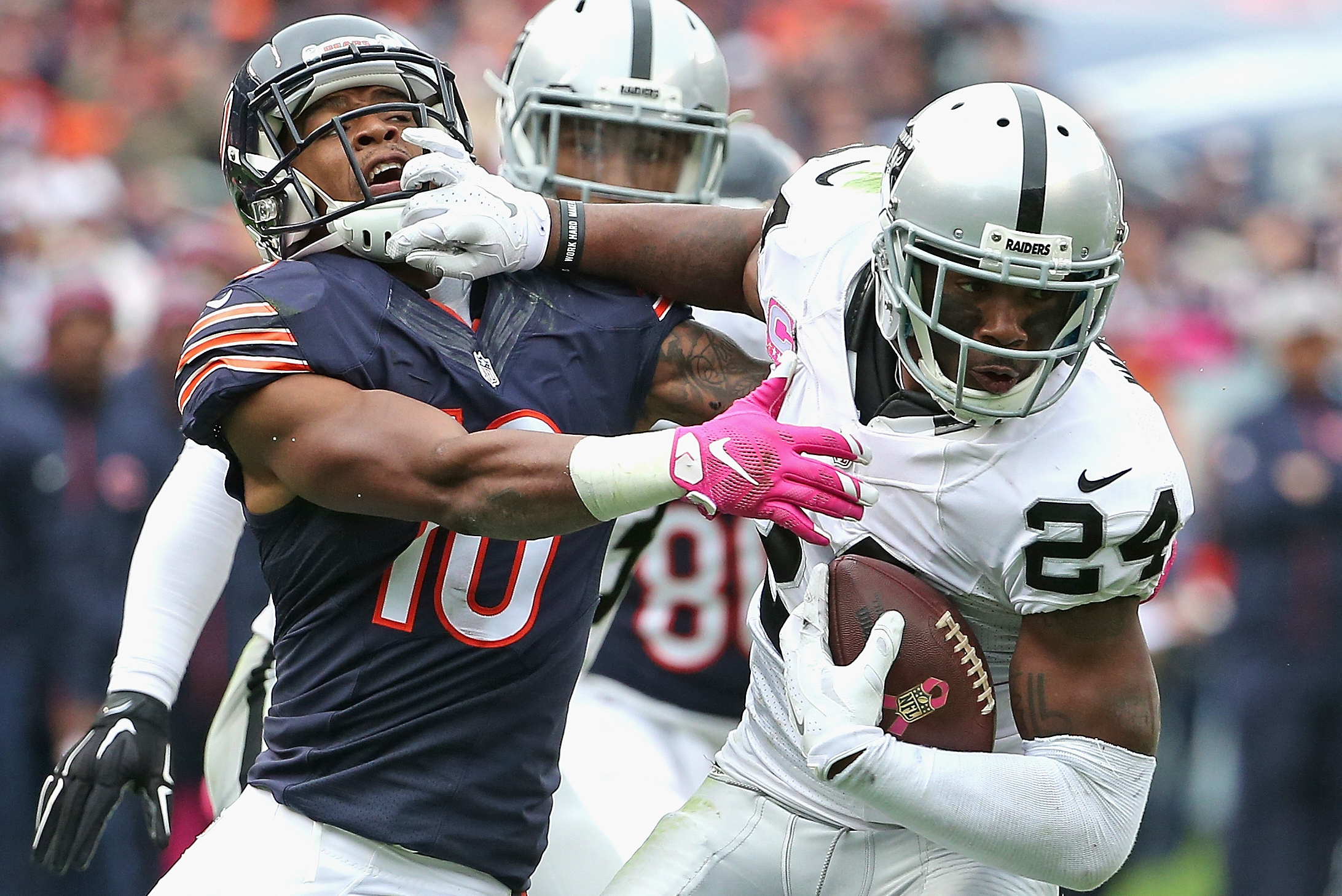 Oakland Raiders Charles Woodson (24) goes high to intercept a