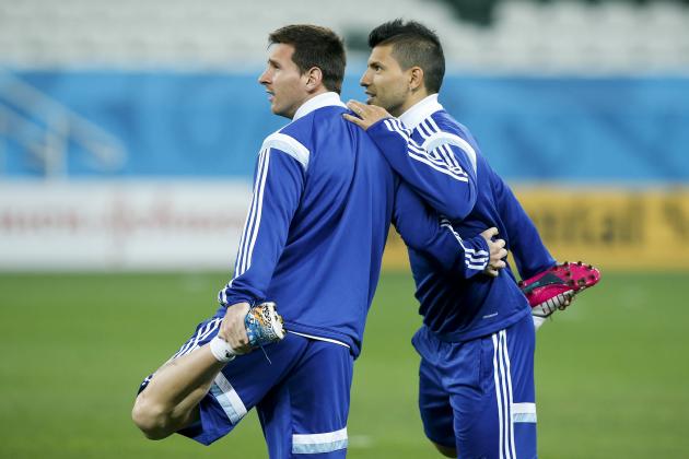 Argentina's Lionel Messi, left, and teammate Sergio Aguero stretch during a training session one day before their World Cup semifinal soccer match against Netherlands at Itaquerao Stadium in Sao Paulo, Brazil, Tuesday, July 8, 2014. (AP Photo/Victor R. Caivano)