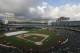 Members of the grounds crew work on the infield at O.co Coliseum before a baseball game between the Oakland Athletics and the Seattle Mariners in Oakland, Calif., Friday, April 4, 2014. The game has been delayed for weather related conditions to the infield. (AP Photo/Jeff Chiu)
