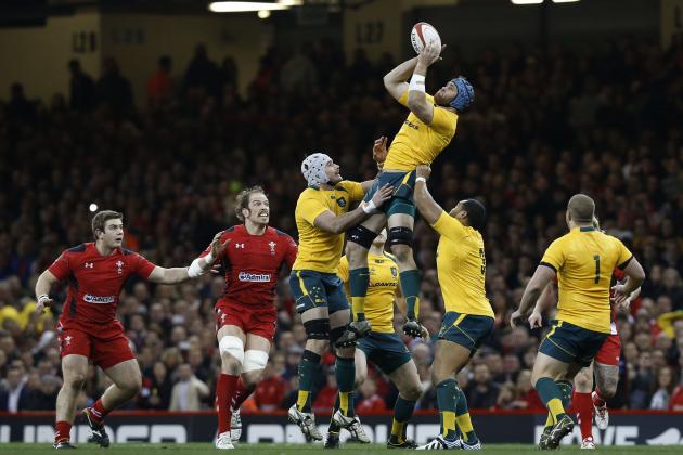 Australia's James Horwill, top, assisted by teammates jumps for the ball against Wales during their autumn international rugby match at Millennium Stadium in Cardiff, Wales, Saturday, Nov. 30, 2013. (AP Photo/Sang Tan)