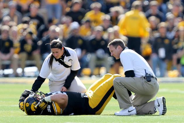 Iowa trainers attend to defensive lineman Drew Ott after he was injured during the second half of an NCAA college football game against Illinois, Saturday, Oct. 10, 2015, in Iowa City, Iowa. (AP Photo/Justin Hayworth)