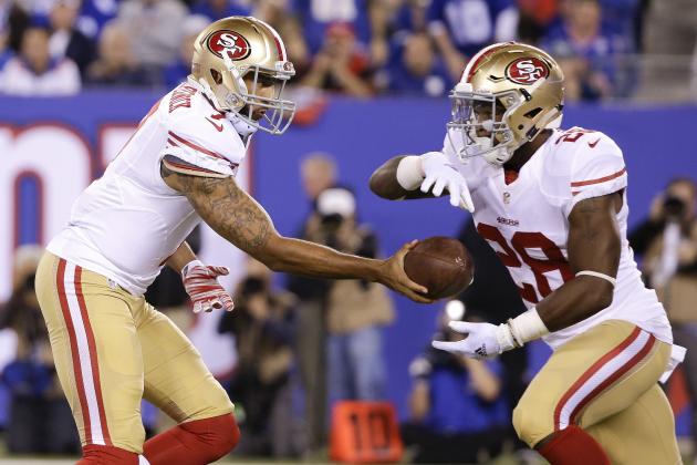 San Francisco 49ers quarterback Colin Kaepernick (7) hands off the ball to San Francisco 49ers running back Carlos Hyde (28) during the second quarter of an NFL football game, Sunday, Oct. 11, 2015, in East Rutherford, N.J. (AP Photo/Seth Wenig)