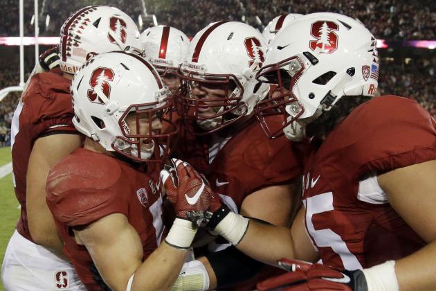 Stanford's Christian McCaffrey, left, is mobbed by teammates after his touchdown run against Arizona during the first half of an NCAA college football game Saturday, Oct. 3, 2015, in Stanford, Calif.  (AP Photo/Marcio Jose Sanchez)