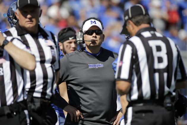 Memphis head coach Justin Fuente, center, watches the scoreboard as a Memphis touchdown is reviewed in the first half of an NCAA college football game against Mississippi Saturday, Oct. 17, 2015, in Memphis, Tenn. The original call was upheld and the touchdown counted. (AP Photo/Mark Humphrey)