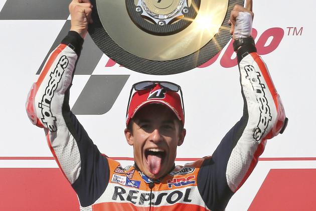 MotoGP rider Marc Marquez of Spain riases his trophy above his head as he celebrates winning the Australian Motorcycle Grand Prix at Phillip Island, Australia, Sunday, Oct. 18, 2015. Marquez took the checkered flag ahead of  Jorge Lorenzo of Spain and Andrea Iannone of Italy. (AP Photo/Rob Griffith)