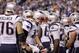 New England Patriots quarterback Tom Brady (12) yells while surrounded by teammates in the second half of an NFL football game against the Indianapolis Colts in Indianapolis, Sunday, Oct. 18, 2015. (AP Photo/John Minchillo)