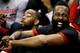 Houston Rockets' James Harden laughs from the bench during the first half of an NBA preseason basketball game against the Phoenix Suns, Tuesday, Oct. 13, 2015, in Phoenix. (AP Photo/Matt York)
