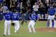 Toronto Blue Jays relief pitcher Roberto Osuna, middle, celebrates their 7-1 win against the Kansas City Royals in Game 5 of baseball's American League Championship Series on Wednesday, Oct. 21, 2015, in Toronto. (AP Photo/Charlie Riedel)