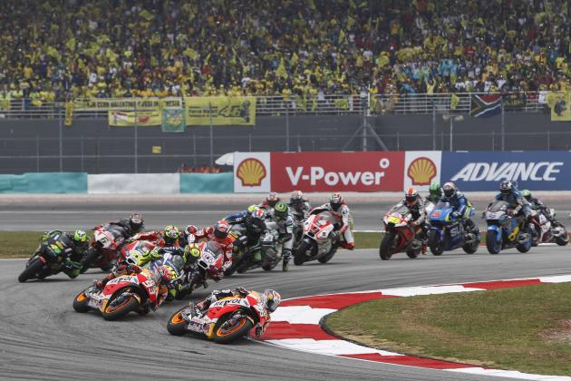 MotoGP rider Dani Pedrosa (26) of Spain leads the pack at the start of the Malaysian Motorcycle Grand Prix in Sepang, Malaysia, Sunday, Oct. 25, 2015. (AP Photo/Joshua Paul)