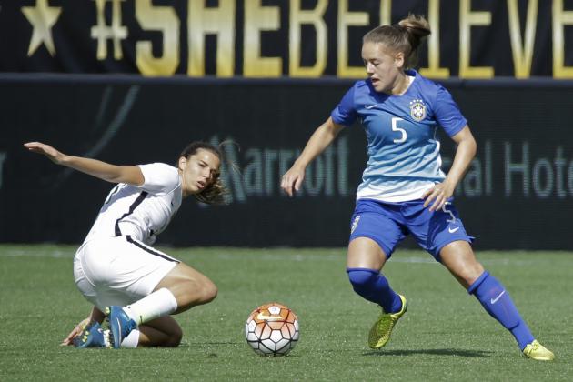 Brazil's Andressa, right, moves the ball past United States's Tobin Heath, left, during the first half of an international friendly soccer match Sunday, Oct. 25, 2015, in Orlando, Fla. (AP Photo/John Raoux)