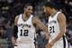 San Antonio Spurs' LaMarcus Aldridge (12) laughs with teammate Tim Duncan during the second half of a preseason NBA basketball game against the Detroit Pistons, Sunday, Oct. 18, 2015, in San Antonio. (AP Photo/Darren Abate)