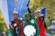 Women's winner Mary Keitany of Kenya, center, holds her trophy and shows her gold medal alongside runner-up and fellow countrywoman Jemima Sumgong, left, and third place finisher Sara Moreira after the trio were awarded their medals in the the 44th annual New York City Marathon in New York, Sunday, Nov. 2, 2014. (AP Photo/Kathy Willens)