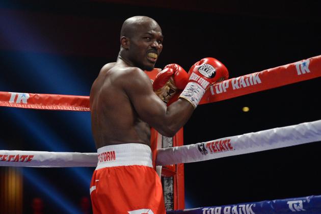 Dec 13, 2014; Las Vegas, NV, USA; Timothy Bradley (red/white trunks) reacts after catching a head butt from Diego Chaves (not pictured) during their welterweight bout at The Chelsea. The bout ended in a draw. Mandatory Credit: Joe Camporeale-USA TODAY Sports