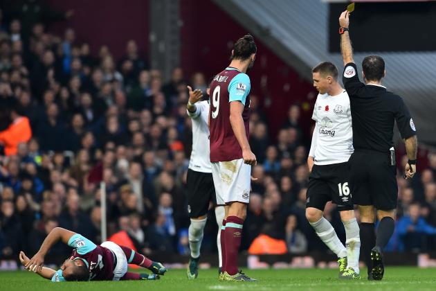 Everton's Scottish-born Irish midfielder James McCarthy (2nd R) receives a yellow card from referee Paul Tierney for a foul on West Ham United's French midfielder Dimitri Payet (L) the English Premier League football match between West Ham United and Everton at The Boleyn Ground in Upton Park, east London on November 7, 2015. AFP PHOTO / BEN STANSALL

RESTRICTED TO EDITORIAL USE. No use with unauthorized audio, video, data, fixture lists, club/league logos or 'live' services. Online in-match use limited to 75 images, no video emulation. No use in betting, games or single club/league/player publications.        (Photo credit should read BEN STANSALL/AFP/Getty Images)