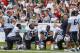 New England Patiots offensive line coach Dave DeGuglielmo, second from right, talks players in front of fans during a joint practice with the New Orleans Saints at the Saints' NFL football training camp in White Sulphur Springs, W.Va., Wednesday, Aug. 19, 2015. (AP Photo/Steve Helber)
