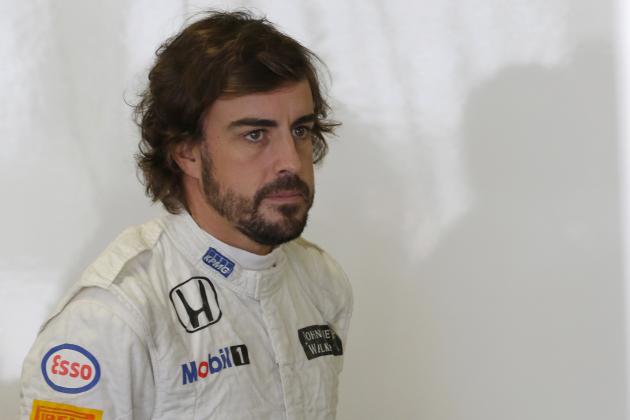 McLaren driver Fernando Alonso of Spain pauses at his garage during the third practice session for the Japanese Formula One Grand Prix at the Suzuka Circuit in Suzuka, central Japan, Saturday, Sept. 26, 2015. (AP Photo/Shizuo Kambayashi)