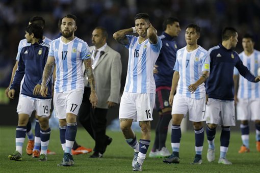 Argentina's Nicolas Otamendi (17), Marcos Rojo (16) and Paulo Dybala (7) leave the field after their 1-1 draw against Brazil during a 2018 World Cup qualifying soccer match in Buenos Aires, Argentina, Friday, Nov. 13, 2015. (AP Photo/Victor R. Caivano)