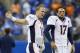 Denver Broncos quarterbacks Peyton Manning (18) and Brock Osweiler (17) stretch during warmups before an NFL football game against the Detroit Lions, Sunday, Sept. 27, 2015, in Detroit. (AP Photo/Rick Osentoski)