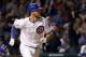 Chicago Cubs' Kris Bryant watches his two-run home run off Milwaukee Brewers starting pitcher Tyler Cravy, also scoring Kyle Schwarber, during the third inning of a baseball game Tuesday, Sept. 22, 2015, in Chicago. (AP Photo/Charles Rex Arbogast)