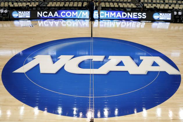The NCAA logo is at center court as work continues at The Consol Energy Center in Pittsburgh, Wednesday, March 18, 2015, for the NCAA college basketball second and third round games. Second round games start on Thursday. (AP Photo/Keith Srakocic)