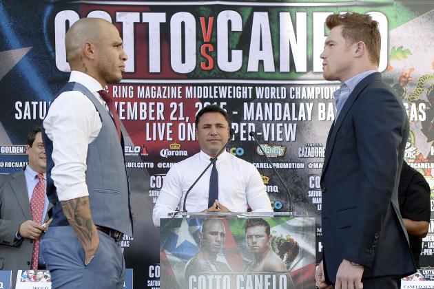 LOS ANGELES, CA - AUGUST 24: Oscar De La Hoya (C), Chairman and CEO, Golden Boy Promotions, looks on as current WBC champion Miguel Cotto (L) and contender Canelo Alvarez, Former WBC and WBA Super Welterweight World Champion, pose during a news conference to announce their upcoming WBC middleweight title bout August 24, 2015, in Los Angeles, California. The WBC middleweight title bout  will take place November 21 at the Mandalay Bay Events Center in Las Vegas, Nevada. (Photo by Kevork Djansezian/Getty Images)