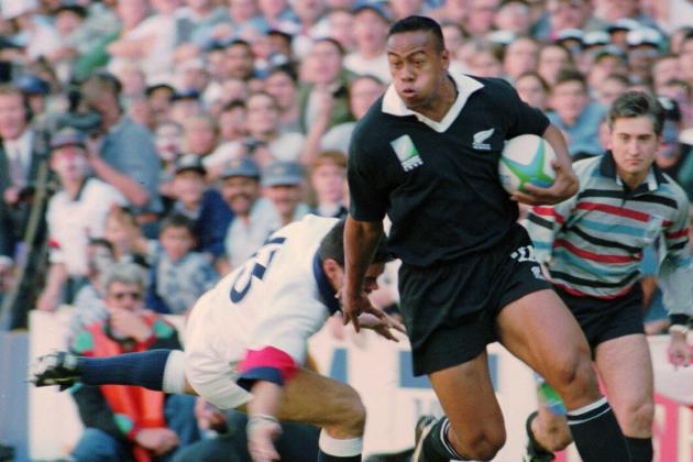 In this June 18, 1995 file photo, New Zealand All Blacks winger Jonah Lomu runs around England's Will Carling on his way to score the opening try in the Rugby World Cup semifinal at Newlands in Cape Town, South Africa. Lomu, whose power and pace revolutionized rugby and whose humility and grace won millions of fans, died early Wednesday, Nov. 18, 2015, New Zealand Rugby said. He was 40. (AP Photo/Ross Setford,File)