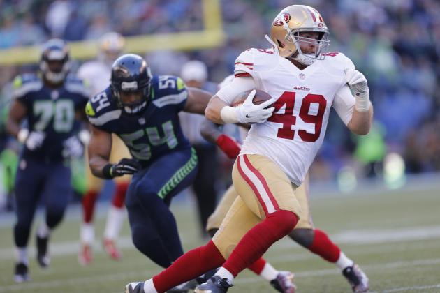 SEATTLE, WA - DECEMBER 14: Bruce Miller #49 of the San Francisco 49ers runs after making a reception during the game against the Seattle Seahawks at CenturyLink Field on December 14, 2014 in Seattle, Washington. The Seahawks defeated the 49ers 17-7. (Photo by Michael Zagaris/San Francisco 49ers/Getty Images)