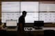 FILE - In this Sept. 9, 2015 file photo, an employee in the software development department of DraftKings, a daily fantasy sports company, walks past screens displaying the company's online system stats in Boston. Top daily fantasy sports companies are fiercely rejecting the idea that their rapidly-growing industry should be considered gambling in the United States. But FanDuel and DraftKings are OK with that label in the United Kingdom. They’re embracing it as a step toward global expansion. U.K. gambling regulators granted a gambling license to DraftKings in August, while FanDuel applied earlier this month for a license as a “gambling software” company. (AP Photo/Stephan Savoia, File)