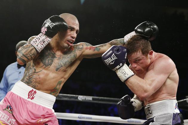 Miguel Cotto, of Puerto Rico, left, fights Canelo Alvarez, of Mexico, during a WBC middleweight title bout Saturday, Nov. 21, 2015, in Las Vegas. (AP Photo/John Locher)