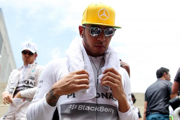 SAO PAULO, BRAZIL - NOVEMBER 15:  Lewis Hamilton of Great Britain and Mercedes GP arrives on the grid with Nico Rosberg of Germany and Mercedes GP before the Formula One Grand Prix of Brazil at Autodromo Jose Carlos Pace on November 15, 2015 in Sao Paulo, Brazil.  (Photo by Mark Thompson/Getty Images)