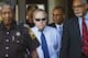 Harvey Updyke, center, exits court with his Lee County Deputy Sheriff escorts and lawyers after the judge called a continuance in the case during jury selection in his trial Thursday, June 21, 2012, at the Lee County Justice Center in Opelika, Ala. Judge Jacob Walker on Thursday delayed the trial of Dyker, an Alabama fan accused of poisoning Auburn's cherished Toomer's Corner oak trees. Walker cited increased media attention stemming from a report this week that the defendant, Harvey Updyke, confessed outside the courtroom. Defense attorneys have asked the judge to move the trial to a different location, saying that the jury pool has been tainted. (AP Photo/Opelika-Auburn News, Vasha Hunt, Pool) (AP Photo/Opelika-Auburn News, Vasha Hunt, Pool)